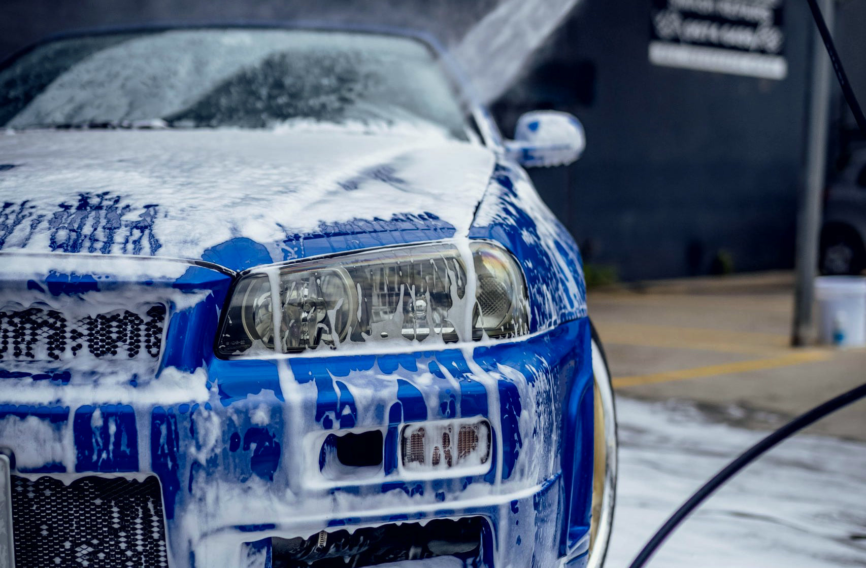 A blue Skyline covered in Cleanazfk snow foam